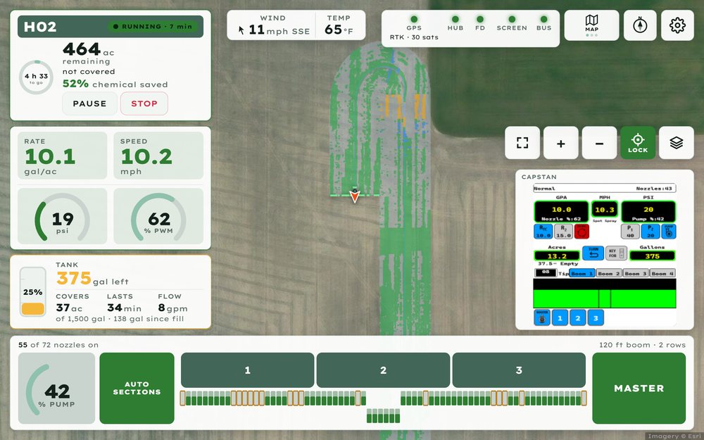 Coverage map on the console after a headland turn: sprayed strips in green, bare ground passed over in grey.